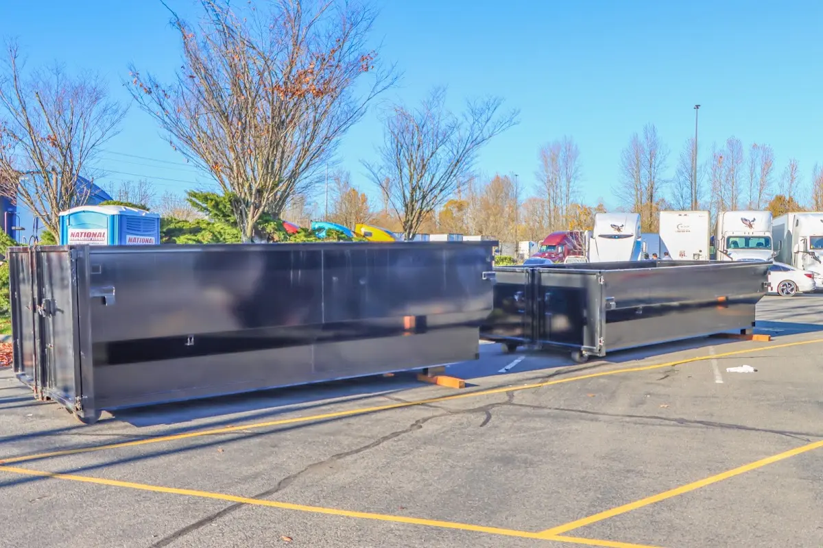 Professional dumpster rental service with roll-off container on residential driveway in Gardena